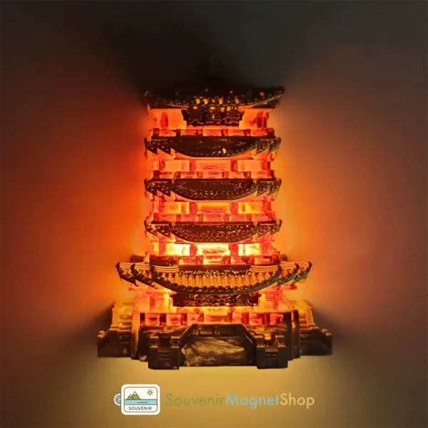 Left side view of the glowing China Wuhan Yellow Crane Tower fridge magnet, showcasing intricate details.