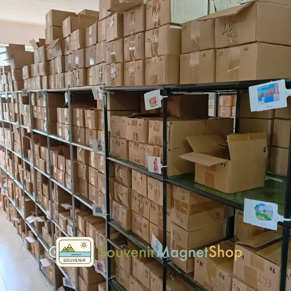 Organized warehouse shelves filled with packaged souvenir fridge magnets, ready for global shipping.