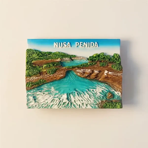 Front view of a 3D souvenir fridge magnet depicting Angel's Billabong in Nusa Penida, Bali, with turquoise waters and lush green cliffs.