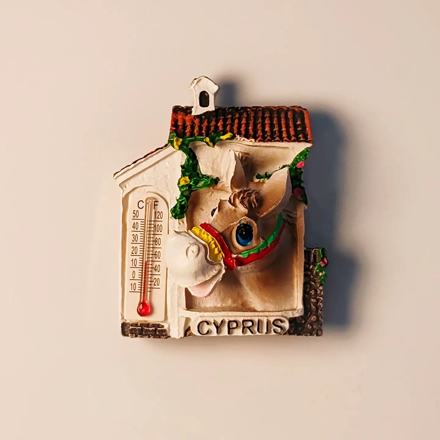 Front view of a vibrant Cyprus donkey house thermometer fridge magnet, hand-painted 3D resin design.