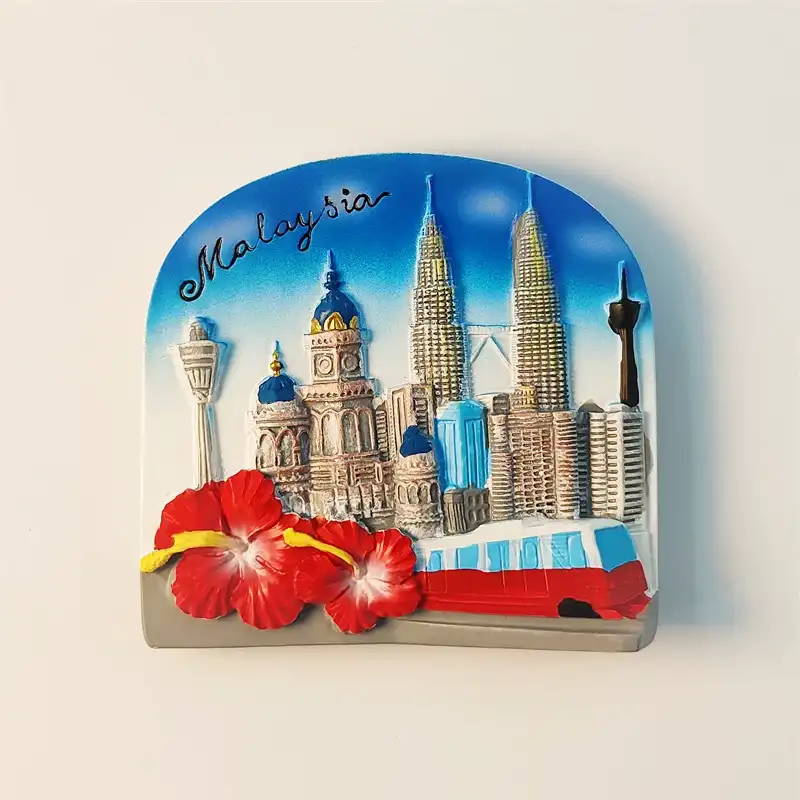 Front view of a vibrant hand-painted Kuala Lumpur fridge magnet featuring the Petronas Twin Towers, KL Tower, and red hibiscus flowers.