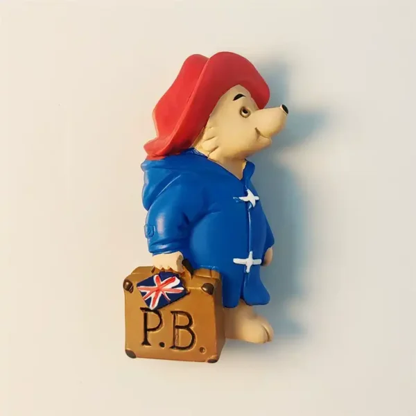 Front view of the London Paddington Bear fridge magnet featuring his iconic blue duffle coat and red hat.