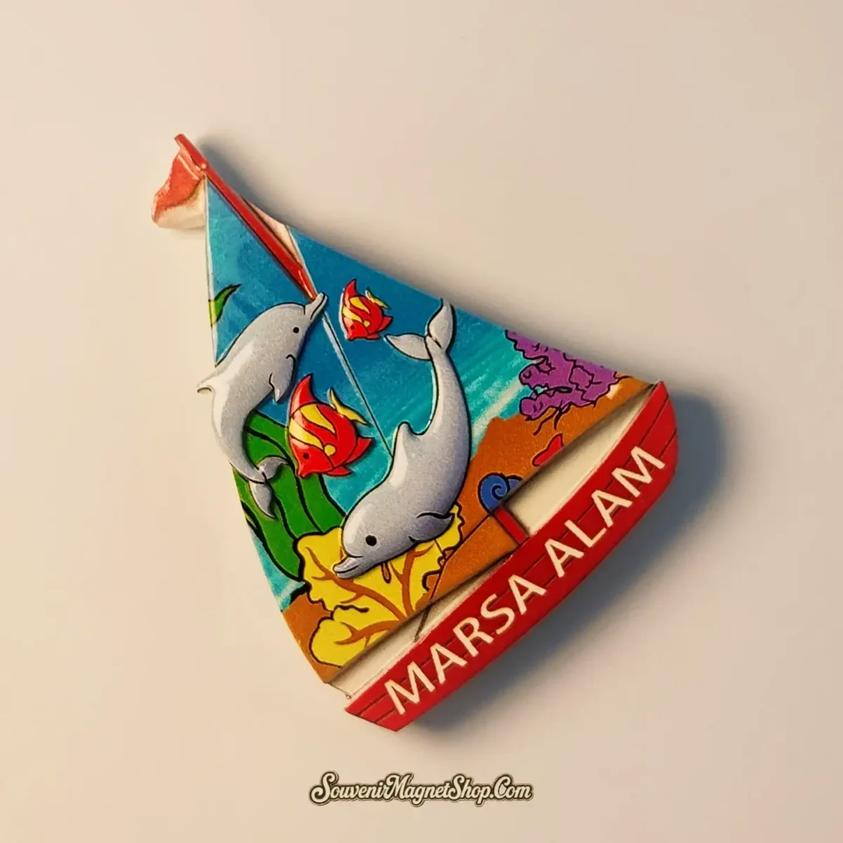 Side view of Marsa Alam dolphin and sailboat magnet showing 3D stereoscopic relief and intricate textures
