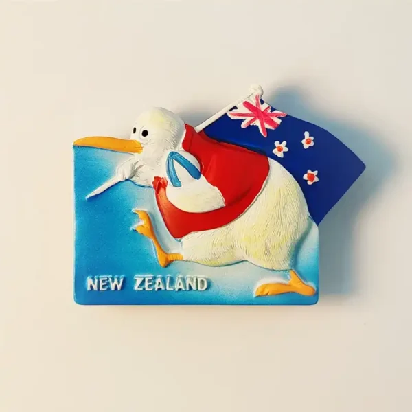 Close-up front view of a New Zealand Kiwi bird and flag fridge magnet, showing textured details and "NEW ZEALAND" text.