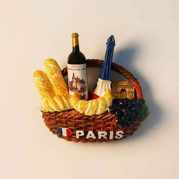 Front view of Paris Eiffel Tower picnic basket fridge magnet with baguettes, croissant, wine, and grapes.