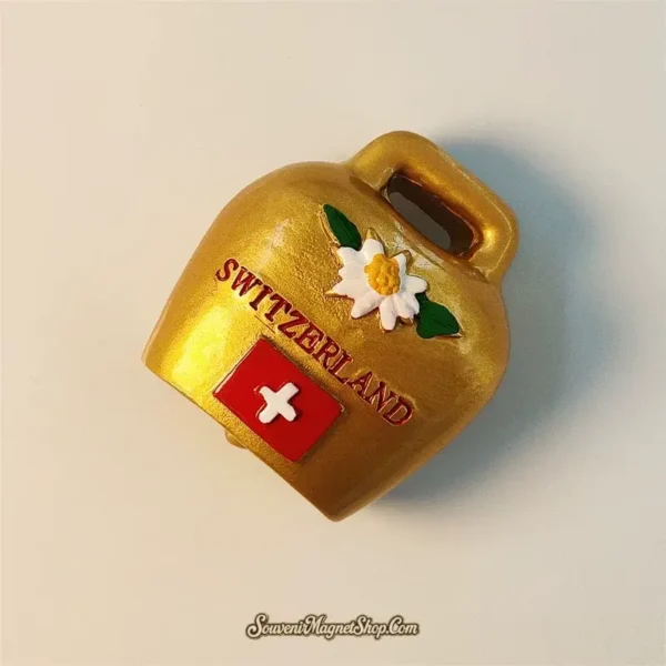 Angled view of the Swiss Alpine travel gift magnet with metallic gold finish and embossed Switzerland text.