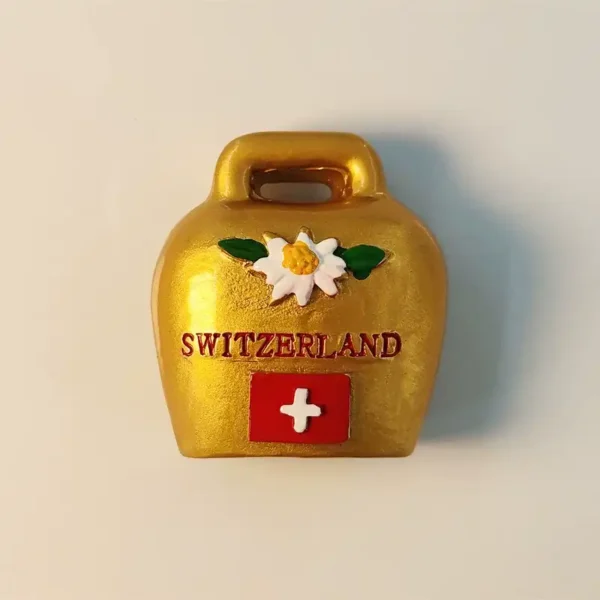 Hand-painted golden Switzerland cowbell fridge magnet featuring a 3D Edelweiss flower and the Swiss national flag.