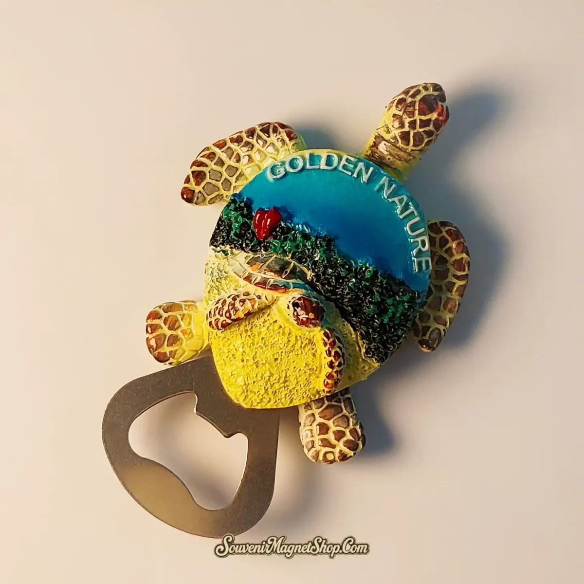 Close-up of Golden Nature sea turtle souvenir magnet highlighting hand-painted beach scenery and shell textures
