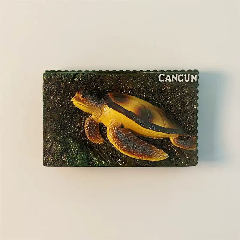 Front view of a Cancun sea turtle fridge magnet, featuring a detailed, hand-painted turtle on a textured background with "CANCUN" text.