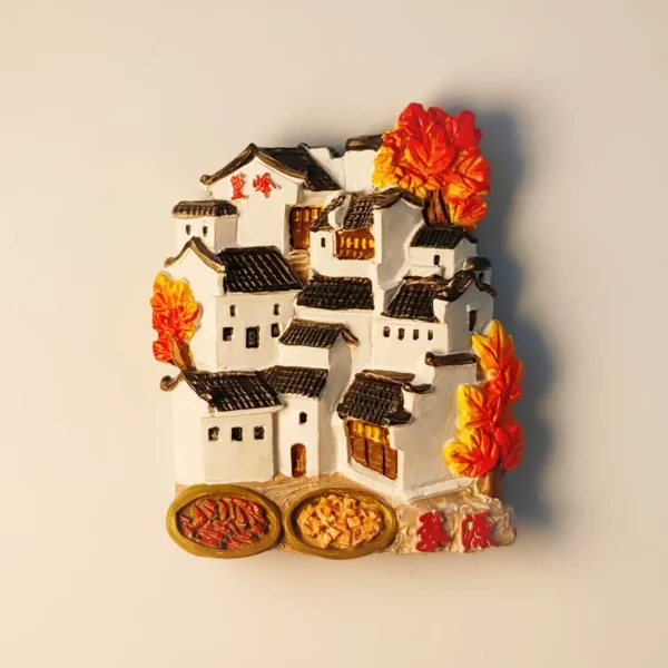 Front view of the China Wuyuan Huangling Autumn Scenery Village fridge magnet, showcasing traditional Huizhou architecture with white walls, black tiles, vibrant red and orange autumn leaves, and baskets of sun-drying produce.