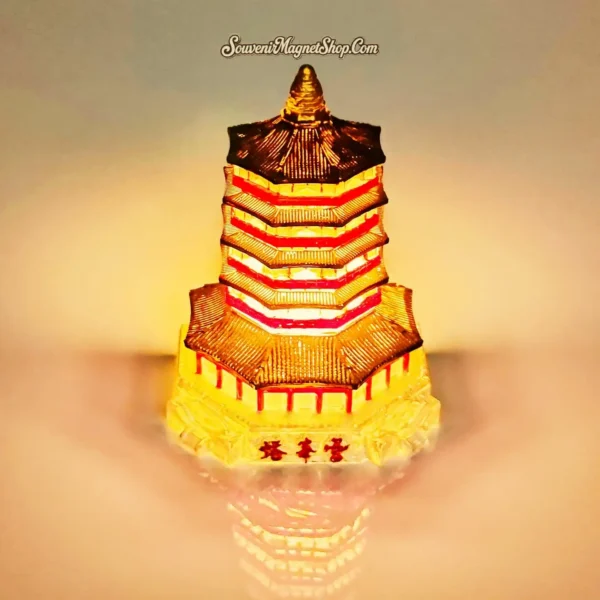 Illuminated 3D Leifeng Pagoda souvenir magnet glowing brightly, showcasing its light-up feature.