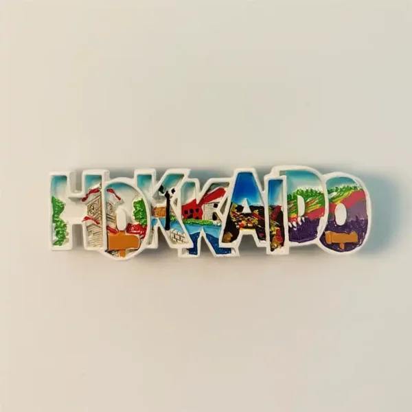 Front view of the Hokkaido landmark word art fridge magnet, showcasing vibrant hand-painted scenery within each letter.