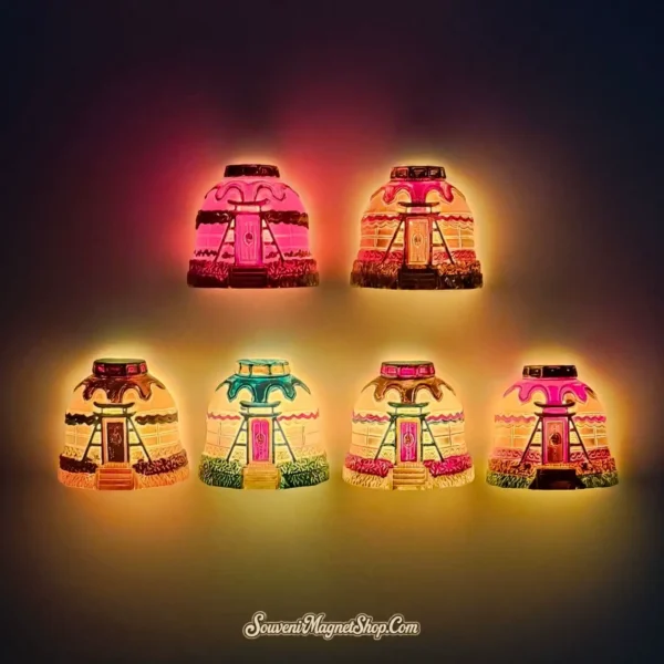 A collection of 3D Mongolian yurt fridge magnets from Inner Mongolia glowing with internal LED lights in the dark.