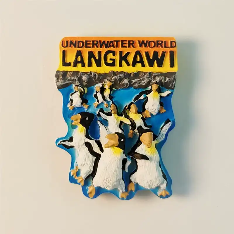 Malaysia Langkawi Underwater World 3D penguins fridge magnet front view, showcasing detailed hand-painted design and "Underwater World Langkawi" text.