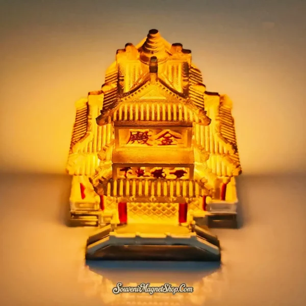 Creative light-up souvenir magnet of the Laojun Mountain Golden Hall glowing with a warm internal light to simulate a sunset glow.