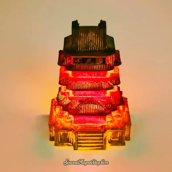 Glowing luminous 3D Tengwang Pavilion souvenir magnet, illuminated to highlight its intricate structure and warm glow.