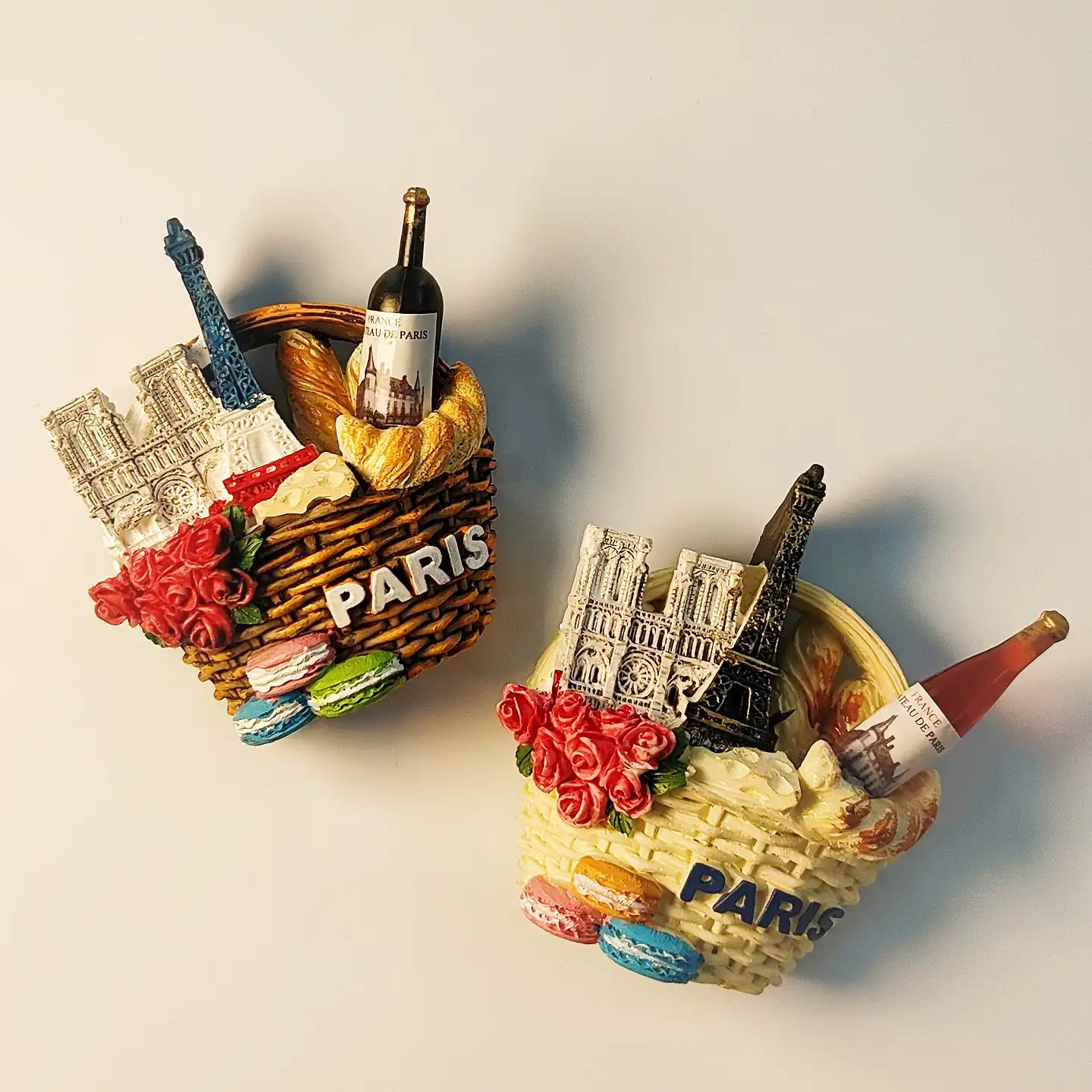 paris-eiffel-tower-notre-dame-basket-fridge-magnet-front Hand-painted 3D Paris fridge magnet featuring the Eiffel Tower, Notre Dame Cathedral, and a wine basket.