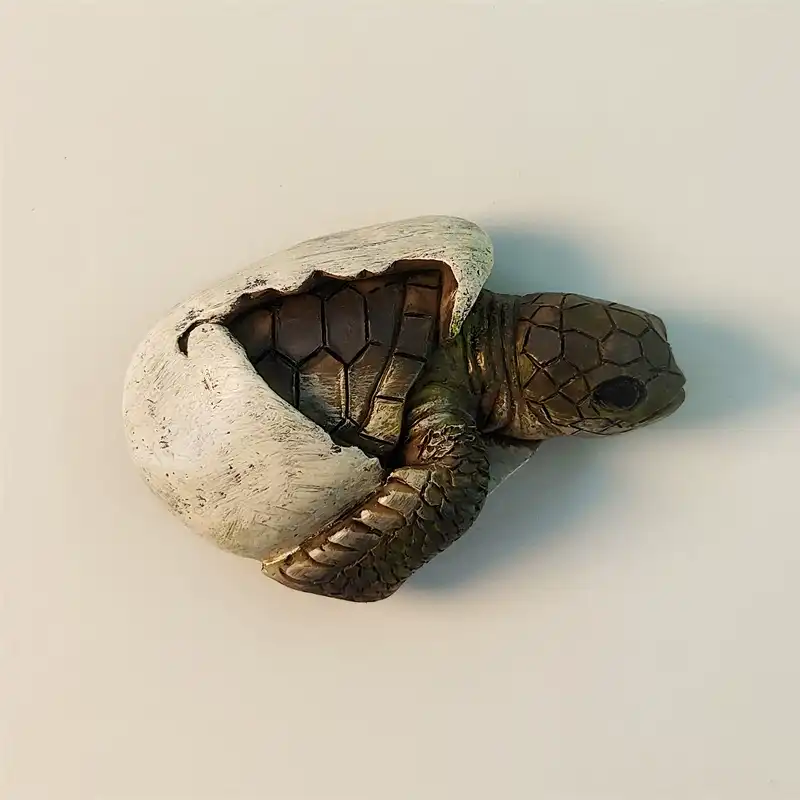 Front view of a detailed 3D baby sea turtle hatching from an egg fridge magnet, capturing the moment of birth and new life.