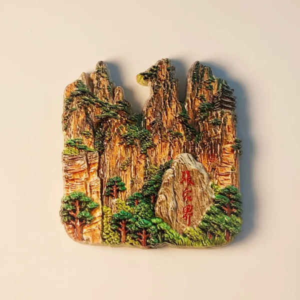 Front view of a detailed, hand-painted Zhangjiajie Wulingyuan Peak Forest fridge magnet showcasing towering sandstone pillars and lush greenery.