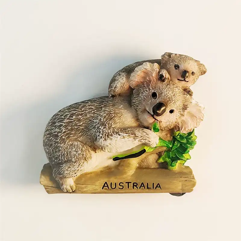 Australia koala mother and baby souvenir fridge magnet front view, realistic 3D resin sculpture on log base with eucalyptus