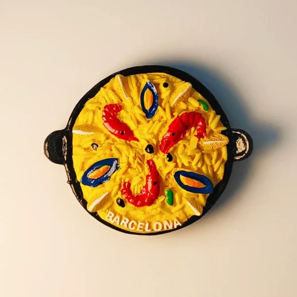 3D resin fridge magnet of Spanish seafood paella in a black pan with Barcelona text.