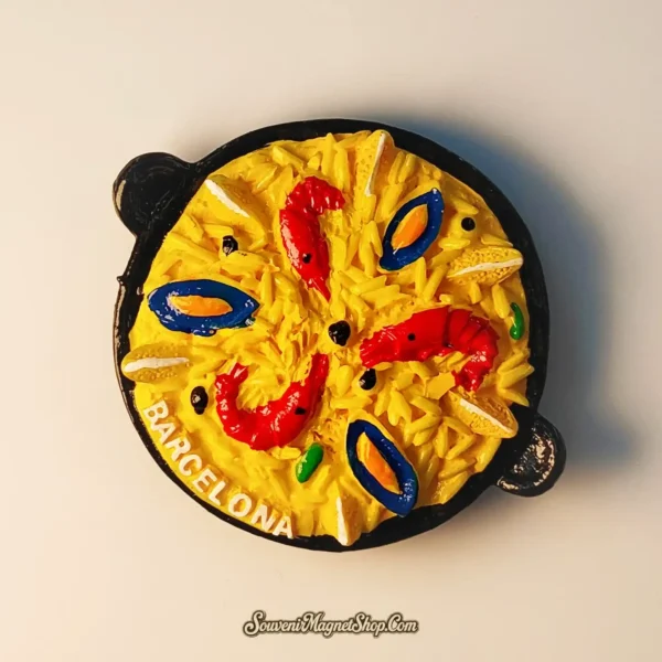 Top view of a decorative Barcelona paella magnet, perfect as a travel gift for culinary fans.