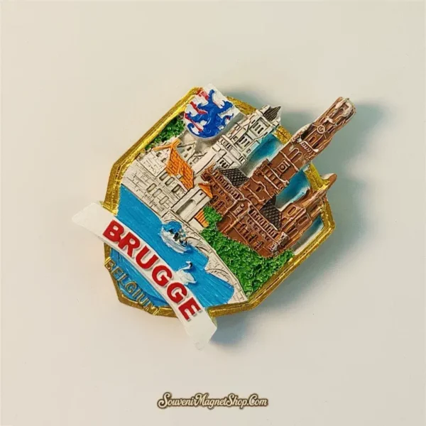 Angled view of Bruges Belgium souvenir magnet showing 3D relief depth with raised Belfry Tower and gold shield border