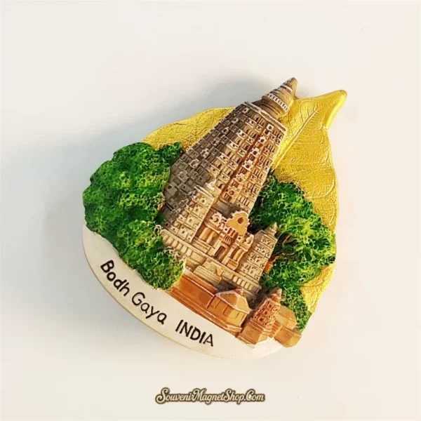 Bodh Gaya India fridge magnet left-front angle showing 3D resin Mahabodhi Temple and golden leaf base
