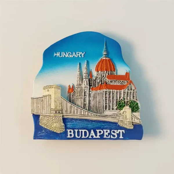 Front view of a Budapest souvenir fridge magnet showcasing the Szechenyi Chain Bridge and the Hungarian Parliament Building.