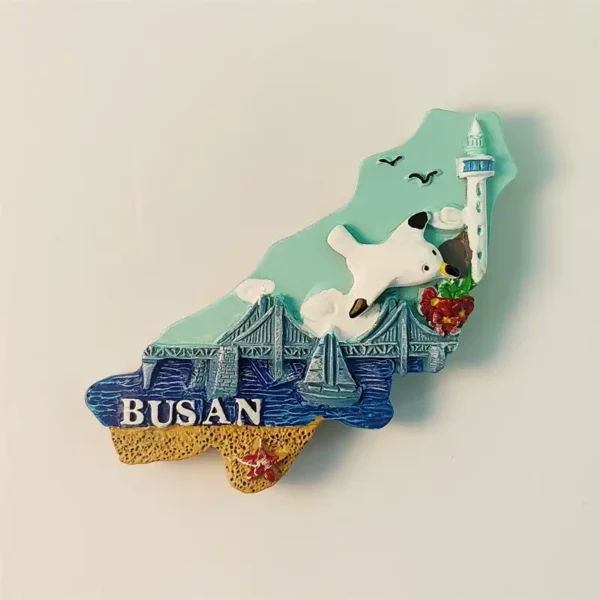 Busan souvenir fridge magnet front view, map-shaped with Gwangan Bridge, Busan Tower and seagull