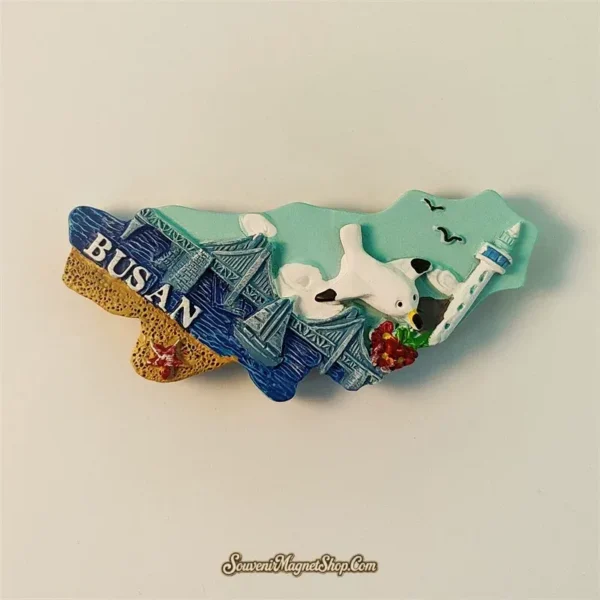 Busan fridge magnet horizontal angle view showing Gwangan Bridge, BUSAN text and red flowers