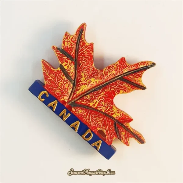 Canada maple leaf fridge magnet left angle showing single leaf 3D resin detail and navy CANADA label