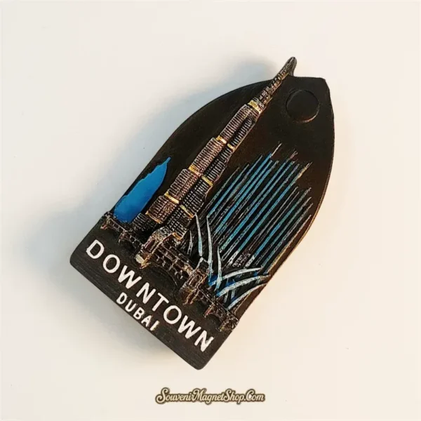 Downtown Dubai fridge magnet left-side angle showing 3D resin Burj Khalifa and fountain jet detail