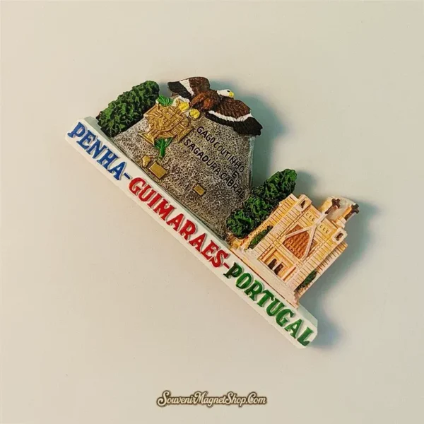 Angled left-side view of Guimarães Penha souvenir magnet highlighting the 3D sculpted eagle and granite rock monument detail