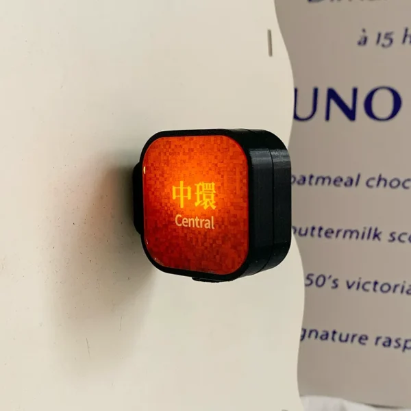 Light-up Hong Kong Central MTR station sign fridge magnet with deep orange mosaic glow on white surface
