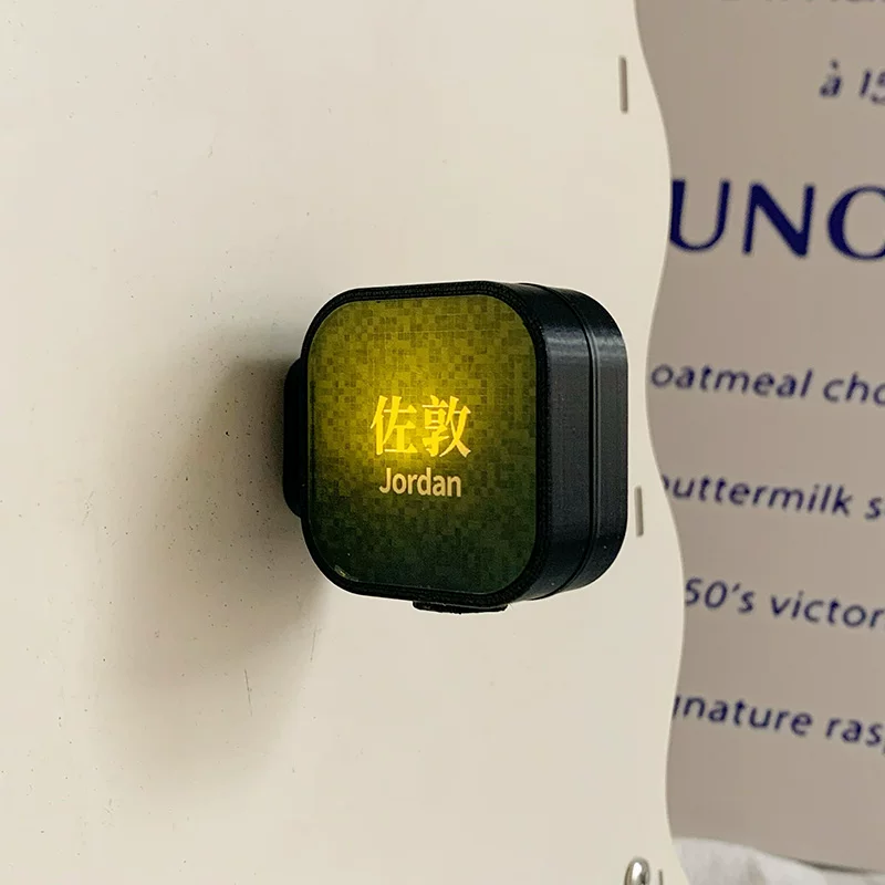 Light-up Hong Kong Jordan MTR station fridge magnet with olive green mosaic glow on white surface