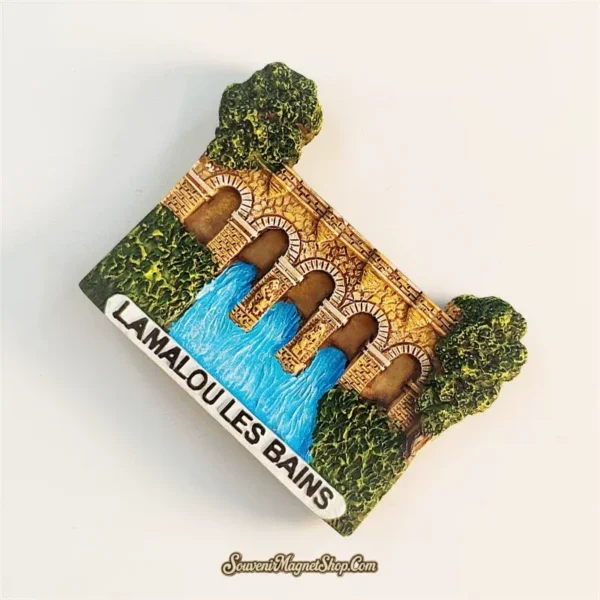 Lamalou-les-Bains fridge magnet left-back angle showing 3D resin aqueduct arches and green trees