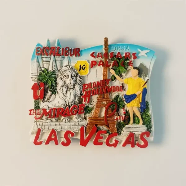 Front view of a detailed Las Vegas fridge magnet featuring Excalibur, Caesars Palace, The Mirage lion, and Eiffel Tower replica.