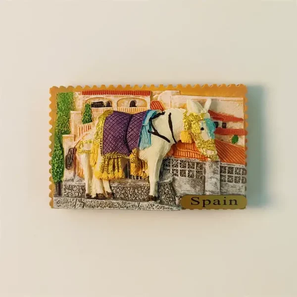 Front view of a 3D Mijas Donkey Taxi fridge magnet, featuring a decorated donkey against white village buildings.