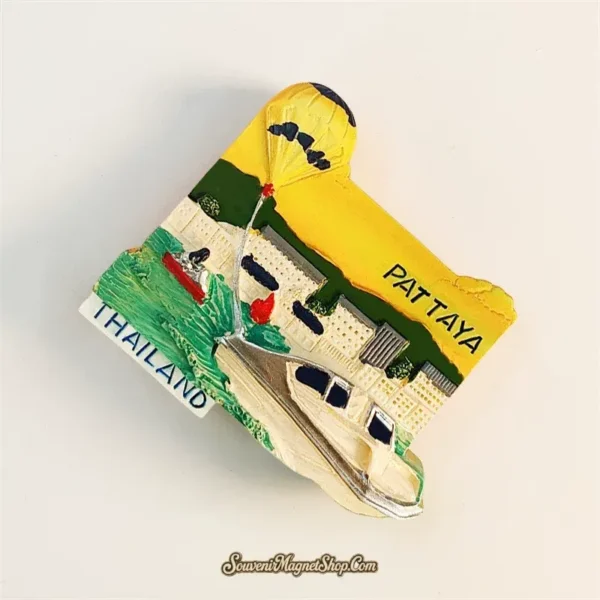 Pattaya Thailand fridge magnet left angle showing 3D depth of parasail parachute speedboat and THAILAND label