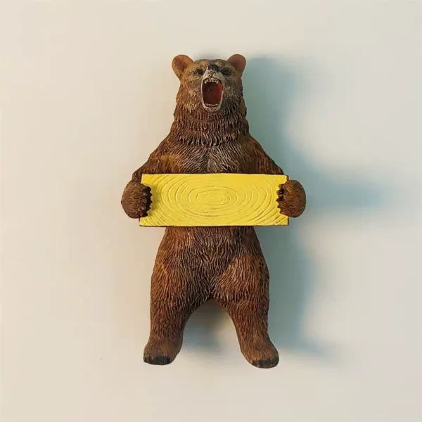 3D Russian brown bear fridge magnet holding a yellow wooden sign with detailed fur texture.