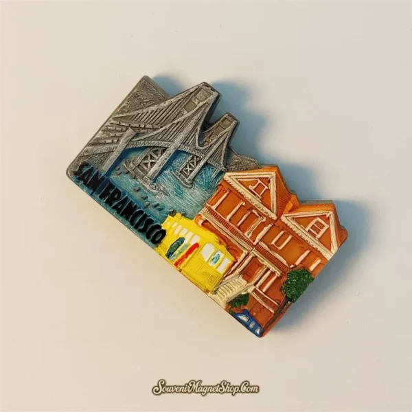 San Francisco souvenir magnet angled left view showing 3D relief depth of Golden Gate Bridge towers and colorful Victorian houses