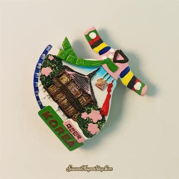 Close-up of a unique Gyeongbokgung Palace and Hanbok themed travel gift magnet from Seoul, South Korea, showing texture.