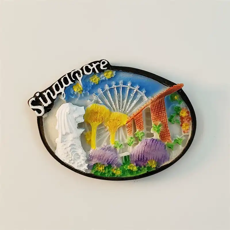Front view of Singapore souvenir fridge magnet oval shape with 3D relief Merlion, Marina Bay Sands, Singapore Flyer and Supertrees