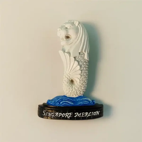 Singapore Merlion fridge magnet front view showing white 3D lion-fish sculpture with blue wave base and SINGAPORE MERLION base inscription