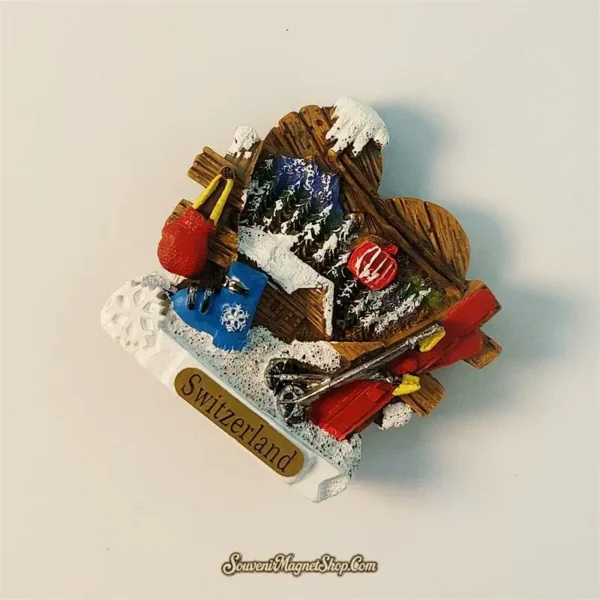 Close-up of the red skis and blue ski boot design on a Switzerland winter travel gift magnet.