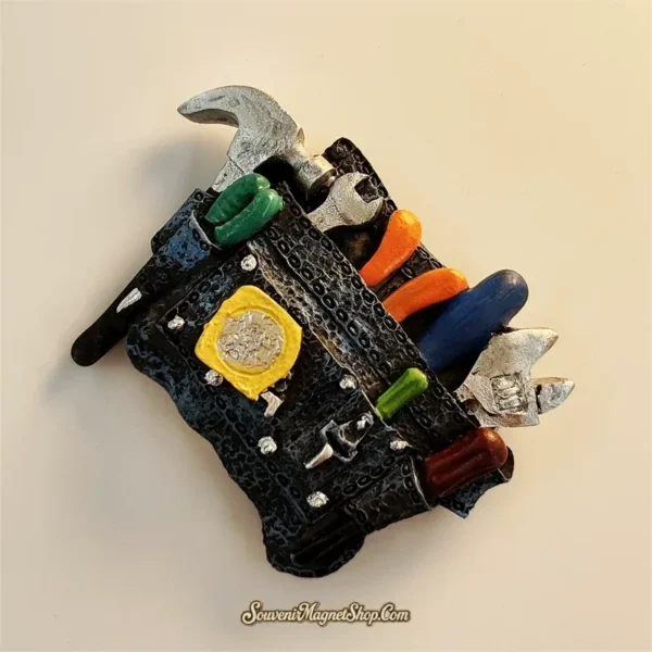 Tool belt fun fridge magnet angled left view showing hammer, wrench and orange tools