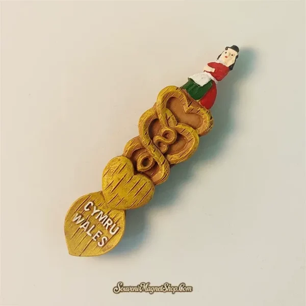 Wales fridge magnet diagonal angle showing carved hearts, scrollwork and Welsh lady costume detail