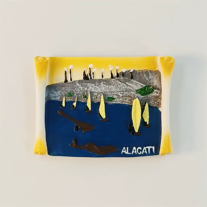 alacati-windsurfing-bay-fridge-magnet-front Front view of Alacati 3D scroll fridge magnet with windsurfing sails on blue bay, cypress trees, and windmills