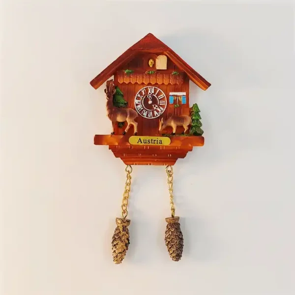 Austria cuckoo clock fridge magnet with hand-painted Alpine chalet, deer figurines, pine trees and golden chains with pinecone weights
